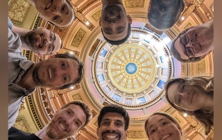 Group at the Capitol. Smiling faces looking down