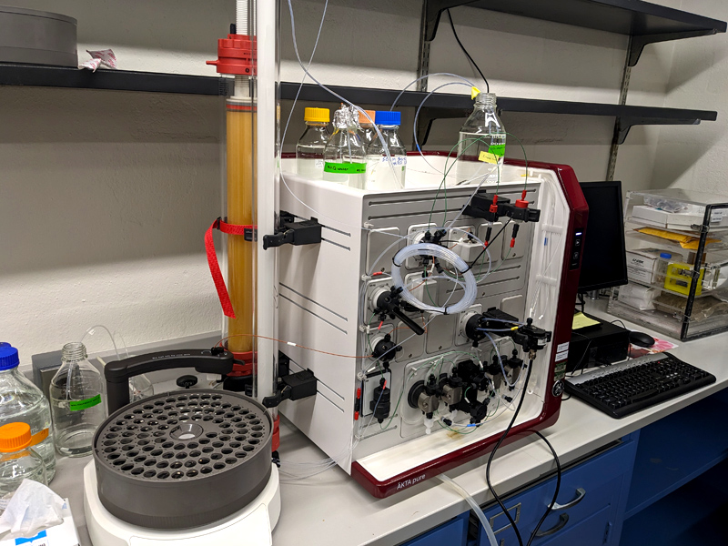 Chromatography system for seperating protiens. Tubes go in and out of a box.