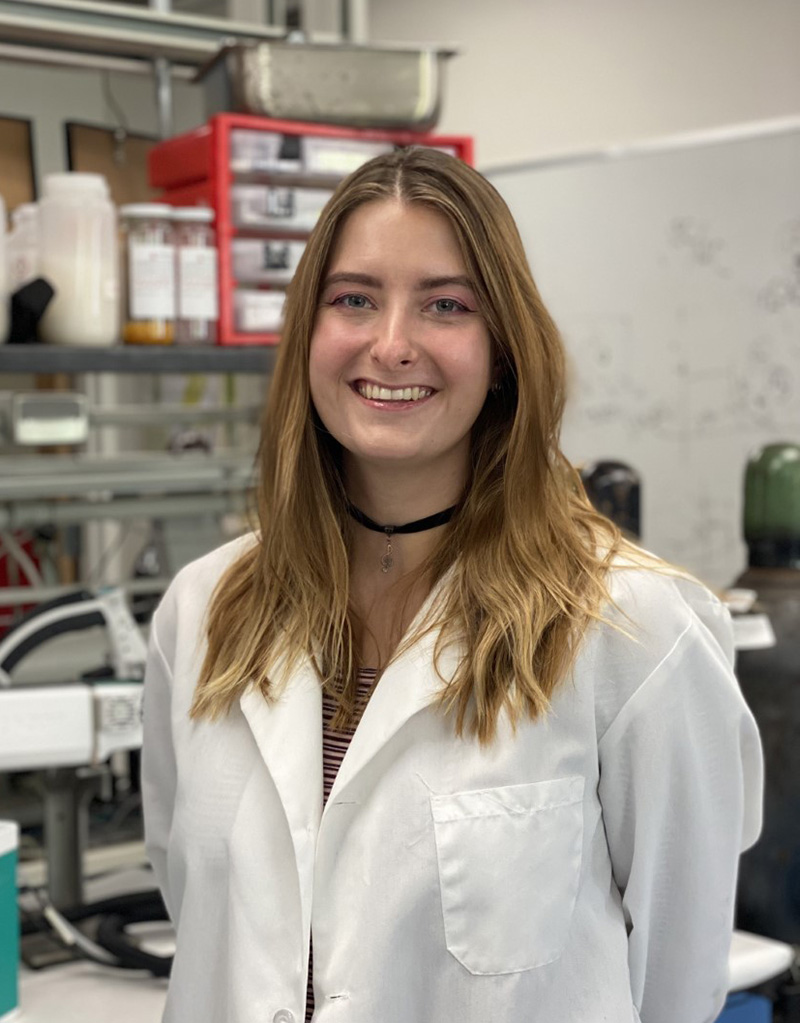 Undergraduate researcher stands in the lab
