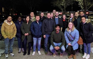 Group photo of lab in front of a resteraunt