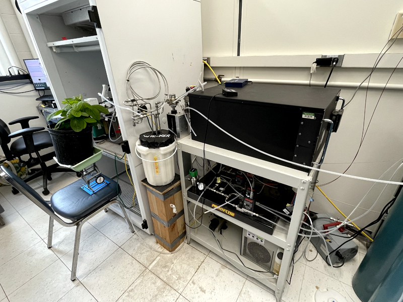 Scientific instruments with plants sit by a growth chamber